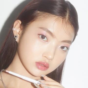 Jeune femme coréenne arborant un maquillage K-Beauty lumineux des lèvres et des yeux