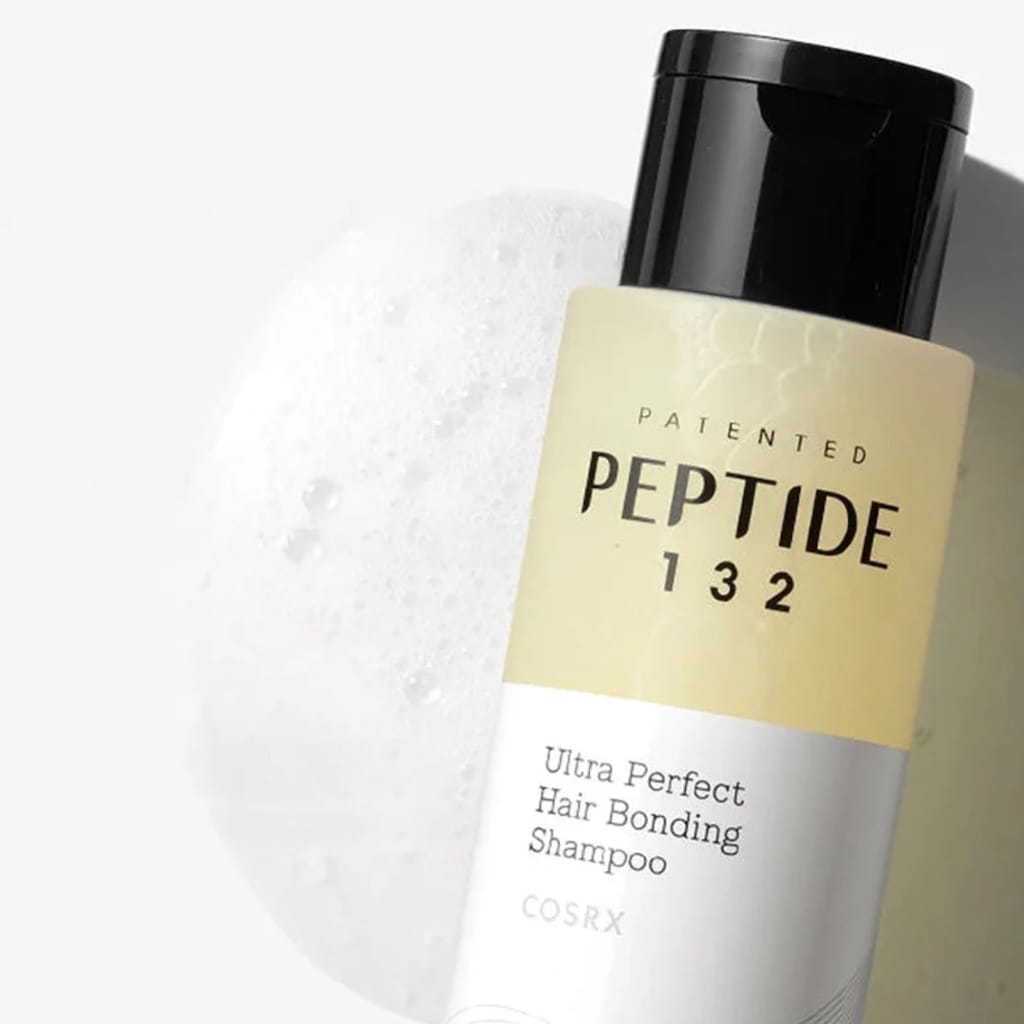 Application et mousse du shampooing COSRX PEPTIDE-132 sur cheveux mouillés.