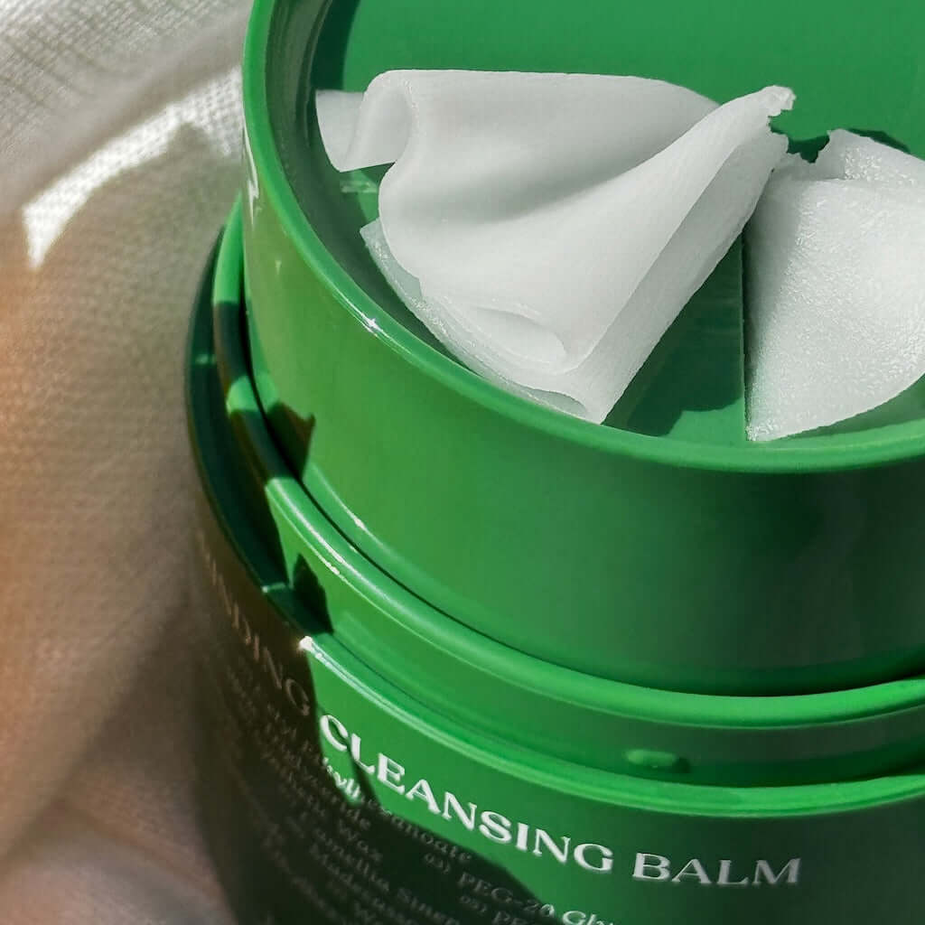 Close-up of the freshly scooped cleansing balm texture. Its formula rich in Camellia and Grape Seed oils transforms into a fine oil to free pores from all impurities.
