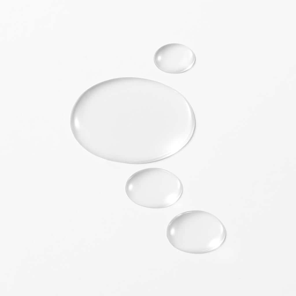 Close-up of the liquid and fresh texture of the ISOI tonic essence. Its light Damask Rose formula instantly penetrates to deeply hydrate the skin and prepare it for subsequent treatments.